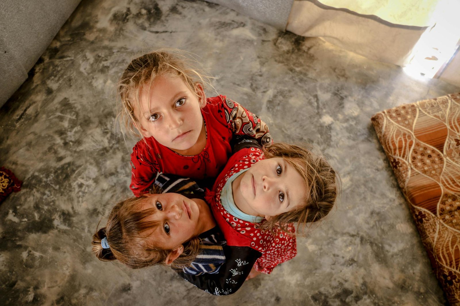 A Photo of Three Kids Looking Up